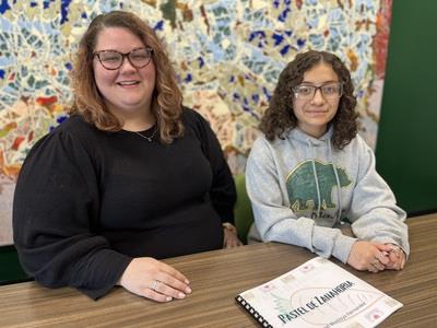 Itzel Montoya Hernandez and Raeanna Carlson show off her book